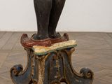 statue of a man on a stool with a hat on his head