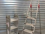 two ladders next to each other in front of a garage door
