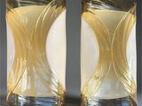 pair of yellow glass vases sitting on top of a table