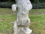 a statue of a bear that is standing in the grass