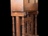 a small wooden cabinet with a door on top of it