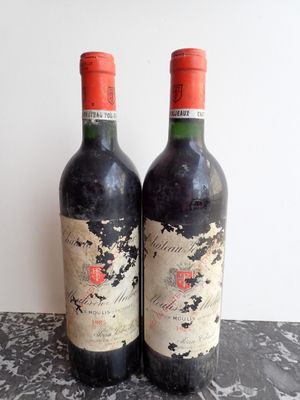 two bottles of wine sitting on top of a table next to each other