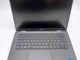 the dell laptop is open and ready to use on the table