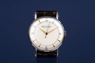 a watch that is sitting on a blue surface