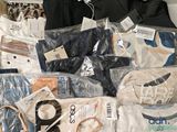 a pile of clothes and other items on a table