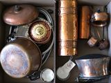a box full of old copper pots and pans