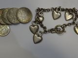 a close up of a bracelet with coins and a coin on it