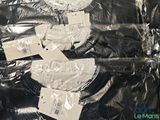 a pile of black clothing wrapped in plastic on a table