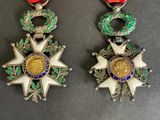 two medals are displayed on a table next to each other