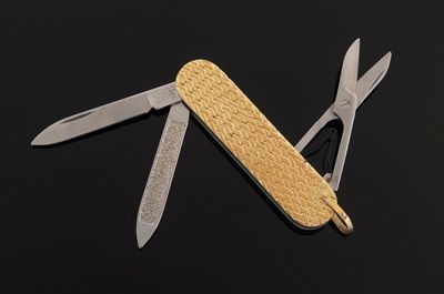 an image of a swiss army knife on a black surface