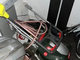 a lawn mower that is sitting in the corner of a room