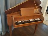 a piano that is sitting in front of a curtain