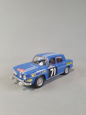 a close up of a blue toy car on a white surface