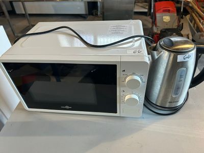 a microwave that is sitting on a counter with a kettle