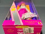 barbie doll in a box with a comb on top of it