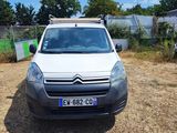 a small white van parked in a lot next to a fence