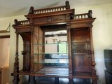 a large wooden cabinet with a mirror in it