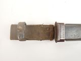 an old belt with a metal buckle on a white surface