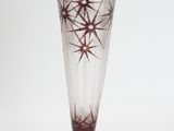 a glass vase that has a star design on it