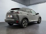 the rear end of a silver suv parked in a garage