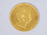 l'image d'une pièce d'or sur laquelle figure le visage d'une femme