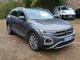 the volkswagen suv is parked in front of a stone building