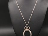 un collier en argent avec un pendentif en forme de corne sur un mannequin