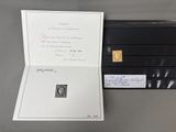 a picture of a black folder with a gold stamp on it