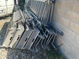 a pile of chairs leaning against a wall next to a van