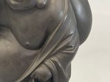a statue of a laughing buddha sitting on a table