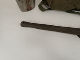 a bag, a hammer, and a cup on a table