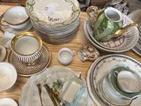 a lot of dishes and cups on the table