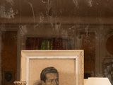 a picture of a man sitting in a chair in a room