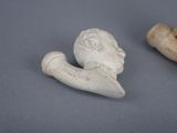 two pieces of pottery that are sitting on a table