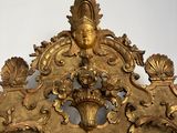 a gold headboard with a decorative design on top of it