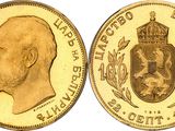 a close up of a gold coin with a crown on it