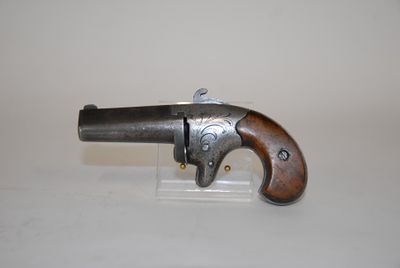 an old gun with a wooden handle on a white surface