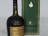 a bottle of liquor sitting next to a box on a table