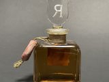 a bottle of perfume with a rope on the top of it