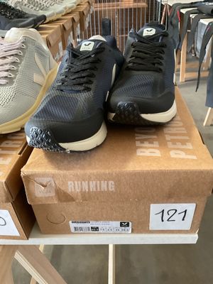 two pairs of running shoes on display in a shoe store