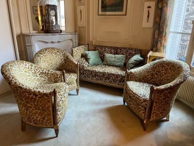 a living room with a couch, chairs, and a fireplace