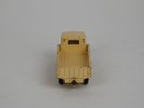 a yellow toy truck that is sitting on a table