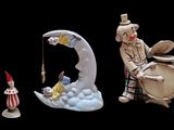 many figurines of clowns that are on a black background