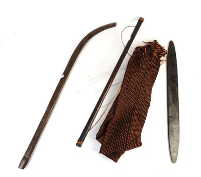 a knife, a cane, and a piece of cloth on a white surface