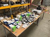 many boxes of electronic equipment on a table in a warehouse