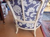 a blue and white chair in a room with a red rug
