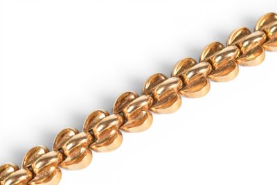 an image of a close up of a chain of gold colored beads