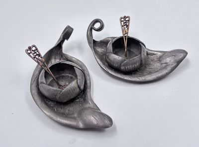 two metal objects that are sitting on a white surface