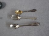 three spoons that are sitting on a table