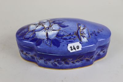 a blue box with flowers on it sitting on a table